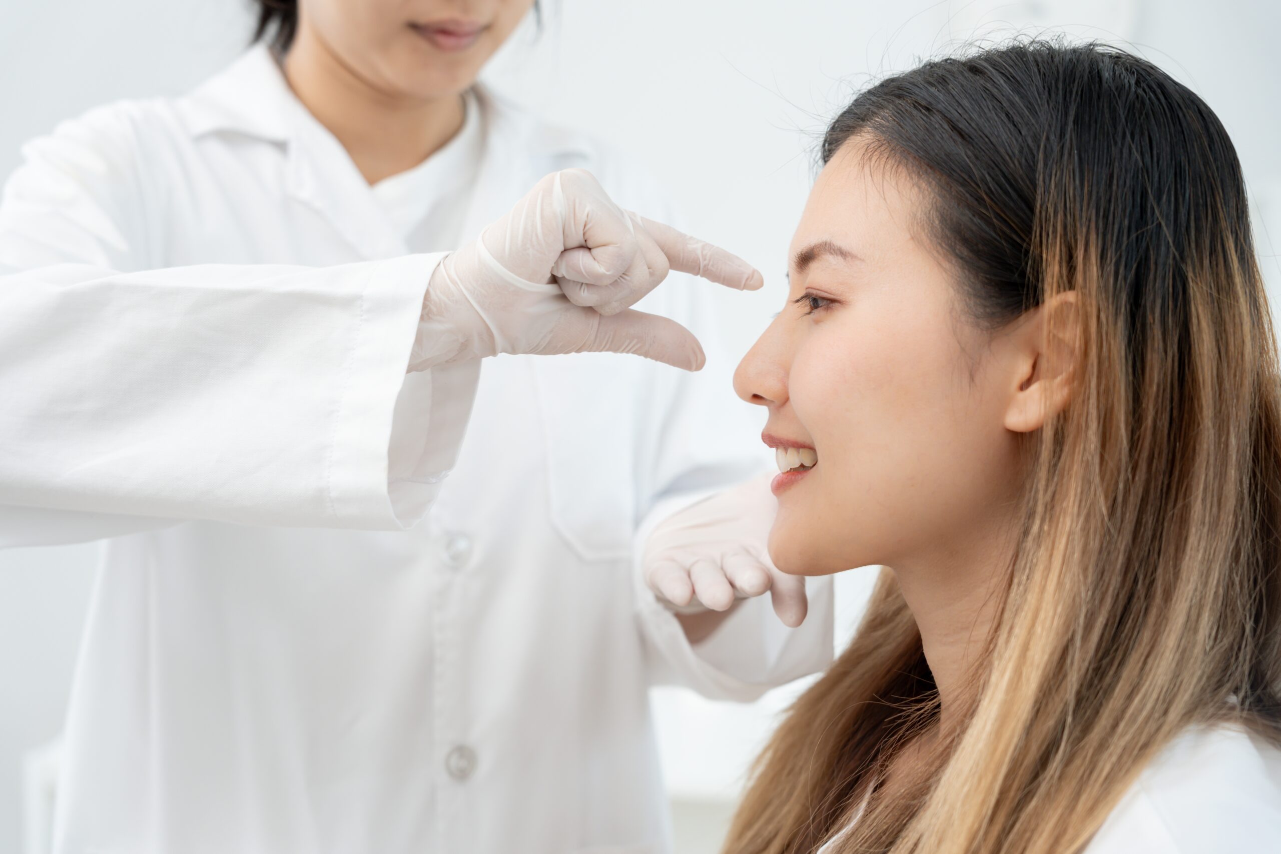 Plastic,Surgery,,Beauty,,Surgeon,Or,Beautician,Touching,Woman,Face,,Surgical